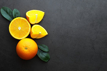 Orange citrus fruit on a stone table. Orange background.