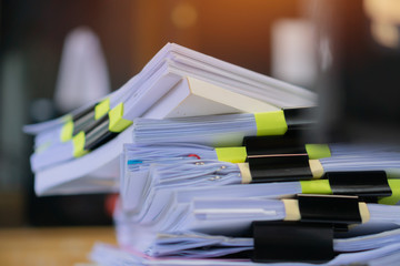 Stack unfinished documents reports files, pile business paper with overwork paperwork on teacher desk office at university, messy sheet book assessment legal folder at workplace. Archive of document