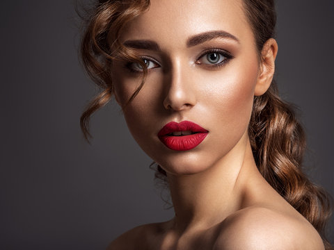 Beautiful face of young woman with red lipstick.