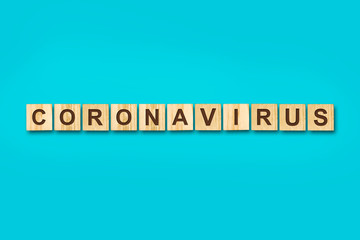Coronavirus. The inscription on wooden blocks on a blue background. Isolated. Viruses.