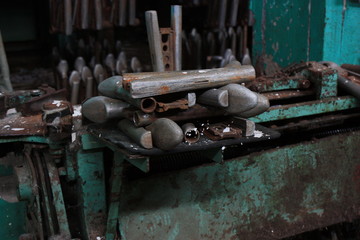 Old shoe pads on abandoned manufacture. old iron shoe from. Shoe form for Valenki boots. Old Felt boot production line.