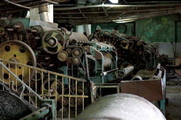 Fototapeta na wymiar Old abandoned factory. Old sheep wool processing machines