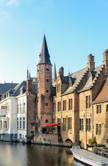 Fototapeta premium Last light of sunset on the buildings on canals in center of Bruges, Belgium
