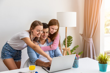 Happy family, father mother and daughter, using notebook computer together, smiling laughing and looking at screen