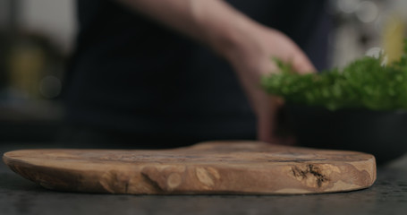 empty olive wood cutting board on terrazzo surface
