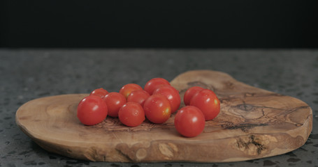 bunch of cherry tomatoes on olive board