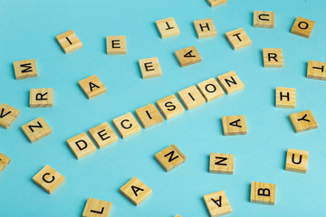 Search for decision concept. The word Decision composed of heaps of different letters on a blue background