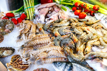 White-headed sea fish, shrimp, crabs, crayfish, mollusks, lobsters are on ice