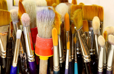 brushes with bristles turned upwards in a painting studio