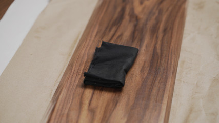 Fototapeta na wymiar applying oil finish to black walnut board