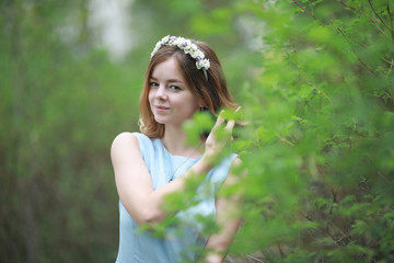 Girl in blue dress in green park