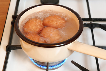 Boiling eggs in saucepan on gas stove