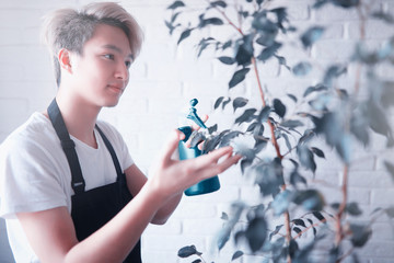 Young Asian boy takes care of plants