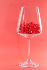 glass red hearts in a glass on a red background for Valentine's day