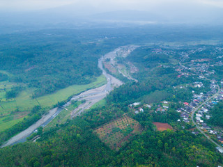 Fototapeta na wymiar aerial view with river in the morning and mountain range misty