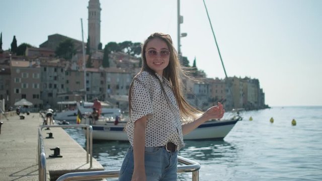 Joyful girl on seafront of Rovinj, Croatia