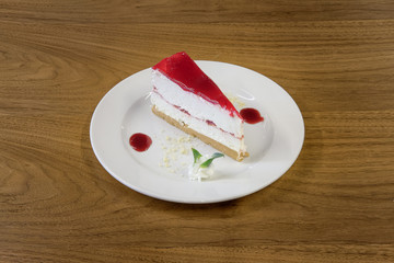 Restaurant cakes served on the wooden table, top view.