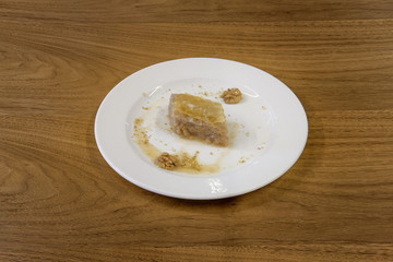 Restaurant cakes served on the wooden table, top view.