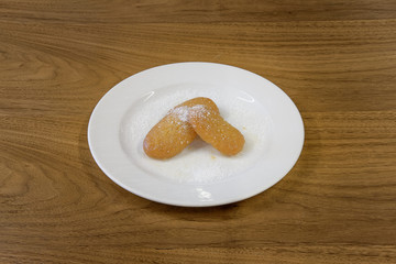 Restaurant cakes served on the wooden table, top view.