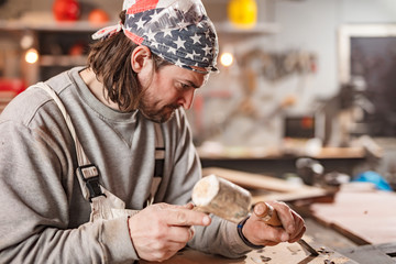 Carpenter working on a old wood in a retro vintage workshop.