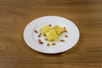 Restaurant cakes served on the wooden table, top view.