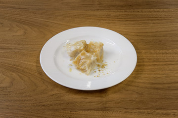 Restaurant cakes served on the wooden table, top view.