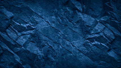 Blue stone background. Toned rock texture. Close-up. Dark blue grunge background with copy space...