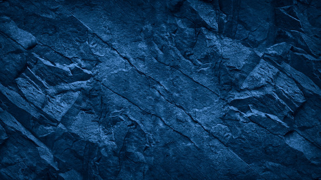 Blue stone background. Toned rock texture. Close-up. Dark blue grunge background with copy space for your design.