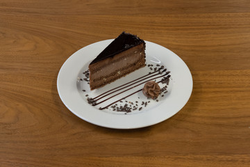 Restaurant cakes served on the wooden table, top view.