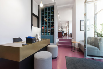 Reception of a bright beauty salon with sofa