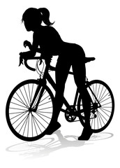 A woman bicycle riding bike cyclist in silhouette