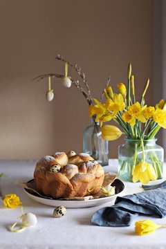 Easter wreath. Osterkranz. Germany traditional Easter cake decorated with quail eggs and fresh flowers.