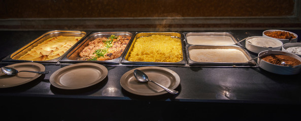 Breakfast on the self-service restaurant table. Omelets, croutons, meat.