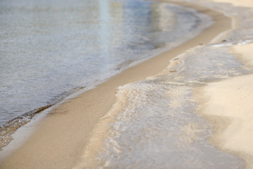 Winter coast with sand, sea and ice