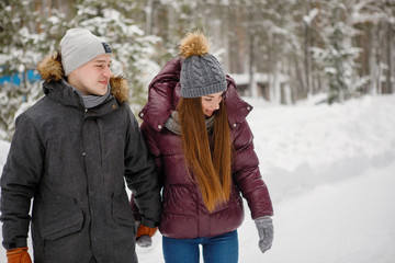 Couple at rink in winter park outside.