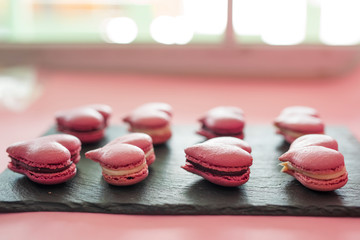 Many pink macaroons in the heart shape