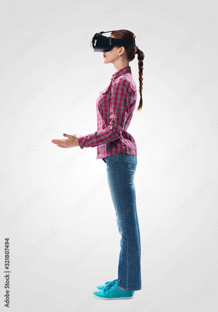 Sticker Young woman wearing VR headset and gesturing