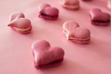 Many pink macaroons in the heart shape