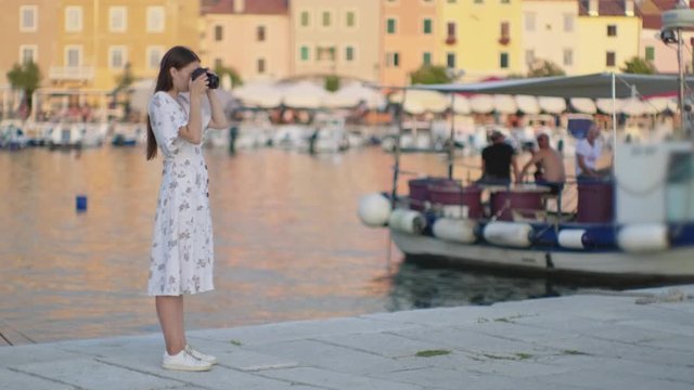 woman tourist is photographing port of Rovinj city in Croatia