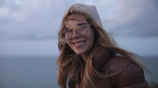 Portrait of young woman teenager in glass on coast of normand.