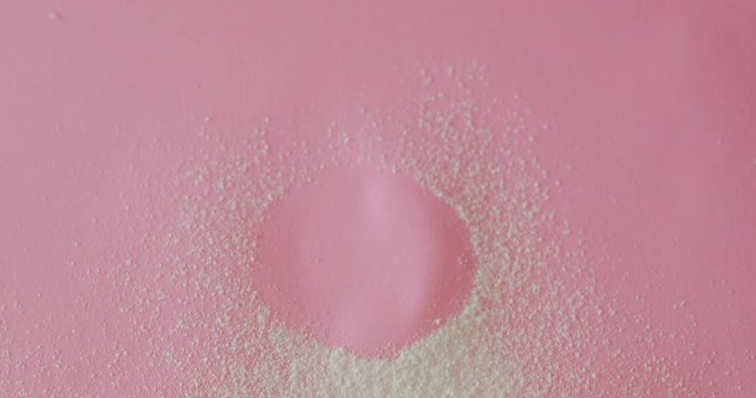 Female hand take one zefir from pink surface, dessert food