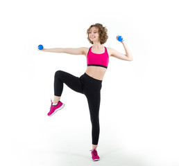 Fitness exercise with dumbbells. Young woman goes in for sports on a white background.