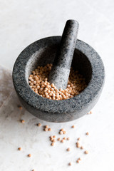 peas with a ceramic mortar for grinding close-up on a white background, selective focus