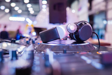 DJ. Headphones on the DJ console. Mixer console. Professional sound equipment. DJ headphones. Equalizer. Sound system in a night club. Concept - music at the party. Work in a night club.