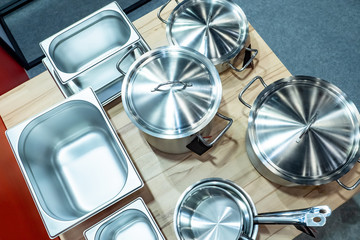 Pans. New stainless steel cookware. Pans and stewpan with labels. Concept - selling equipment for a restaurant. Sale of dishes for the hotline. The opening of the restaurant. Gastronorm containers