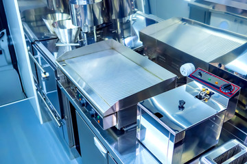 Equipment in the cafe. Frying surface in the restaurant kitchen. Stainless steel kitchen equipment....