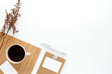 Notepad coffee cub dry flowers modern business background with copy space for your text. Top view, flat lay.