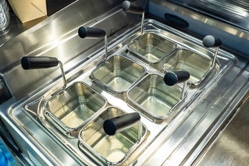 Empty deep fryer. Deep-fryer with six sections. Fry different ingredients in one deep fryer. Purity. Concept - reading tools for the kitchen. Means against fat. Chef equipment. Kitchen tools.