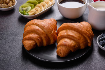 Delicious breakfast with fresh croissants and ripe berries