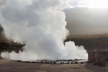Steam of one of the beautiful El Tatio geysers at sunrise, Chile. Located at 4,320 meters above the sea level El Tatio geyser valley is one the highest elevated geyser field in the world